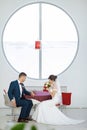 Bride and groom sitting in indoors cafe Royalty Free Stock Photo