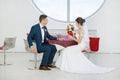 Bride and groom sitting in indoors cafe Royalty Free Stock Photo