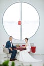 Bride and groom sitting in indoors cafe Royalty Free Stock Photo