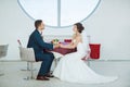 Bride and groom sitting in indoors cafe Royalty Free Stock Photo