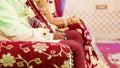 Bride and groom sitting together for puja, A typical Hindu wedding rituals