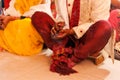 Bride and groom sitting together for puja, A typical Hindu wedding rituals