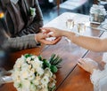 The bride and groom are sitting at a wooden table in a cafe Royalty Free Stock Photo