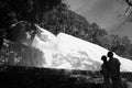 Bride and groom stand against a huge Nirvana Buddha in Vietnam