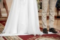The bride and groom stand on an embroidered towel during a church wedding