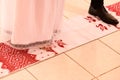 The bride and groom stand on an embroidered towel during a church wedding, a Ukrainian church tradition