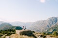 Bride and groom stand on the Gorazda fort against the background of the mountains. Drone