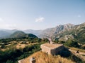 Bride and groom stand on the Gorazda fort on Mount Lovcen. Drone