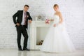 Bride and groom stand near fireplace Royalty Free Stock Photo