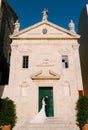 Bride and groom stand on the steps of the Catholic church of Saint apostle Mark. Perast. Montenegro Royalty Free Stock Photo