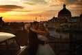 Bride and groom stand in thr front of a great cityscape and under a yellow sky over them Royalty Free Stock Photo