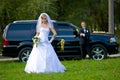 Bride and groom standing in front of wedding car Royalty Free Stock Photo