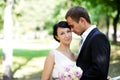 Bride and groom standing together in a park Royalty Free Stock Photo