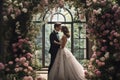 A bride and groom standing together under a beautiful floral arch on their wedding day, Newlyweds sharing a kiss under an arch of