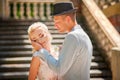 The bride and groom in the summer. Loving wedding couple in the city of Dnipro, Ukraine. Groom with a hat. Close-up kiss and tende Royalty Free Stock Photo