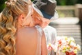 The bride and groom in the summer. Loving wedding couple in the city of Dnipro, Ukraine. Groom with a hat. Close-up kiss and tende Royalty Free Stock Photo