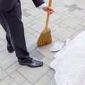 Bride and groom sweeping the pieces of happiness on wedding.