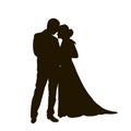 A bride and groom on their wedding day about to kiss in silhouette Royalty Free Stock Photo