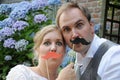 Bride and groom pose giggly in front of a photo-booth Royalty Free Stock Photo