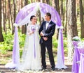 Bride and Groom Under wedding arch. Royalty Free Stock Photo