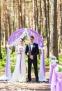 Bride and Groom Under wedding arch. Royalty Free Stock Photo