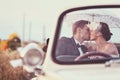 Bride and groom in a vintage car Royalty Free Stock Photo
