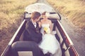 Bride and groom in a vintage car Royalty Free Stock Photo