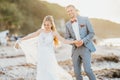 Bride and groom walking on the beach Royalty Free Stock Photo