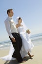 Bride and Groom walking on beach