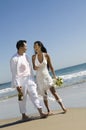 Bride and Groom walking on beach