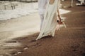 Bride groom walking on choppy Beach, bride has flowers in her hand Royalty Free Stock Photo