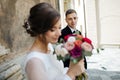 Bride and groom walking in a sunny city at large buildings Royalty Free Stock Photo