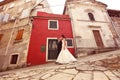 Bride and groom walking on streets Royalty Free Stock Photo