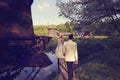 Bride and groom walking on a wooden bridge Royalty Free Stock Photo