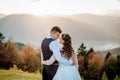 Bride and groom watch the sunset standing on the hill Royalty Free Stock Photo
