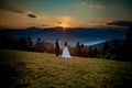Bride and groom watch the sunset standing on the hill Royalty Free Stock Photo