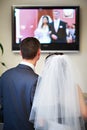 Bride and groom watch the video of his wedding Royalty Free Stock Photo