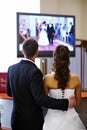 Bride and groom watch the video of his wedding Royalty Free Stock Photo