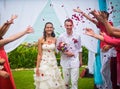 The bride and groom after the wedding ceremony. Guests showered the newlyweds with rose petals