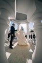 bride and groom in wedding clothes dance in gazebos or rotunda in the park.