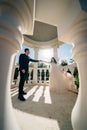 bride and groom in wedding clothes dance in gazebos or rotunda in the park.