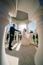 bride and groom in wedding clothes dance in gazebos or rotunda in the park.