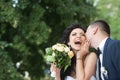 Bride and groom at wedding day outdoor on spring nature. Bridal couple, happy newlywed woman and man embracing in green Royalty Free Stock Photo