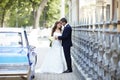 The bride and groom on the wedding day to the car. Royalty Free Stock Photo