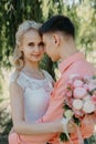 Bride and groom at wedding Day walking Outdoors on spring nature. Bridal couple, Happy Newlywed woman and man embracing Royalty Free Stock Photo