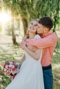 Bride and groom at wedding Day walking Outdoors on spring nature. Bridal couple, Happy Newlywed woman and man embracing Royalty Free Stock Photo