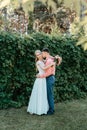 Bride and groom at wedding Day walking Outdoors on spring nature. Bridal couple, Happy Newlywed woman and man embracing Royalty Free Stock Photo