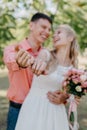 Bride and groom at wedding Day walking Outdoors on spring nature. Bridal couple, Happy Newlywed woman and man embracing Royalty Free Stock Photo