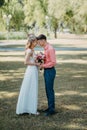 Bride and groom at wedding Day walking Outdoors on spring nature. Bridal couple, Happy Newlywed woman and man embracing Royalty Free Stock Photo