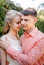 Bride and groom at wedding Day walking Outdoors on spring nature. Bridal couple, Happy Newlywed woman and man embracing Royalty Free Stock Photo